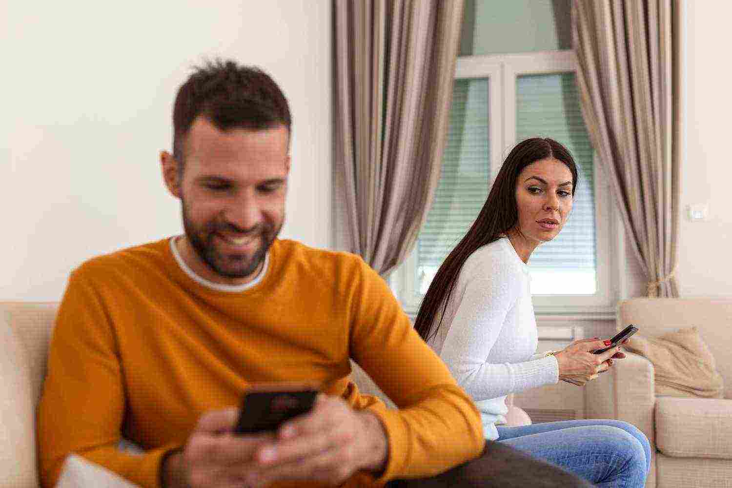 jealous suspicious mad wife arguing with obsessed husband holding phone texting cheating cellphone distrustful girlfriend annoyed with boyfriend mobile addiction distrust social media dependence