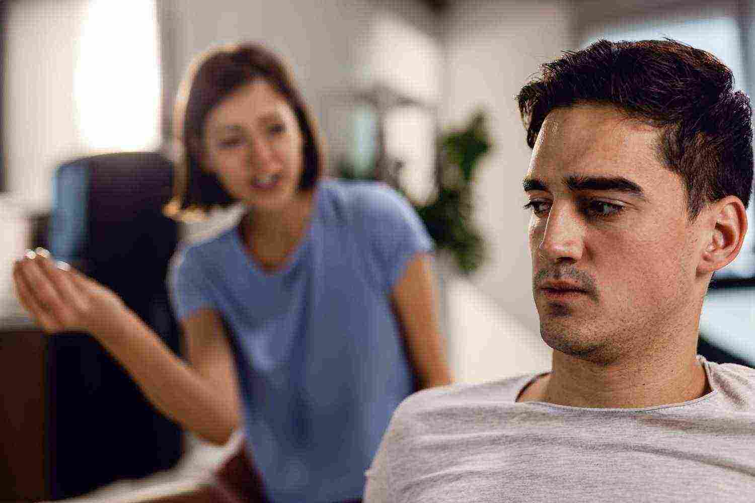 sad man having conflict with his girlfriend thinking their relationship difficulties