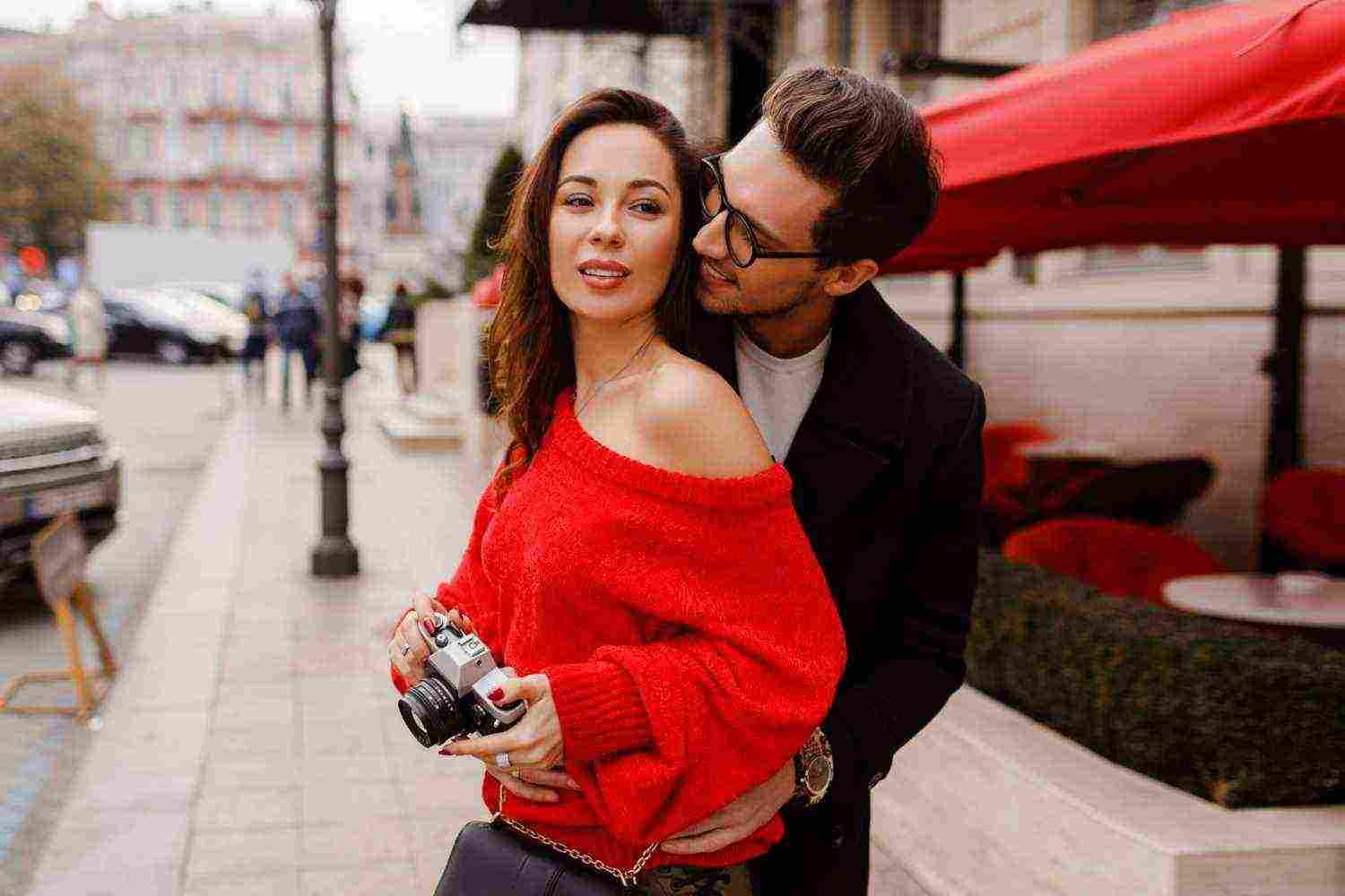 couple love embarrassing posing street holiday romantic mood lovely brunette woman holding film camera