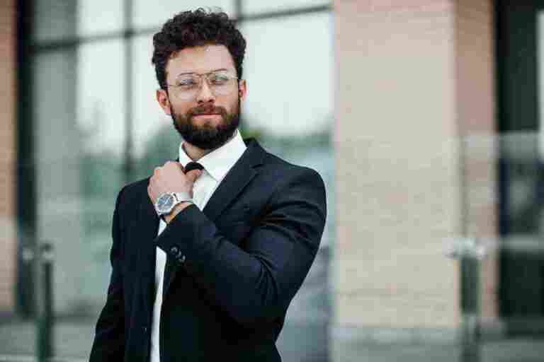portrait handsome man black business suit with watch his hand