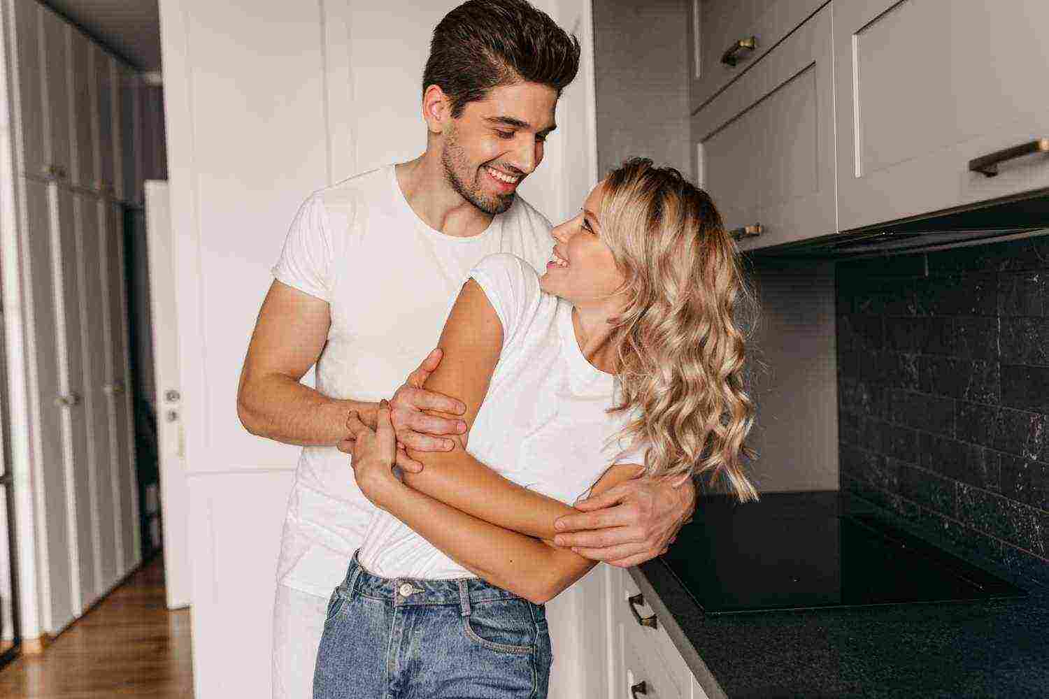 romantic couple dancing together with sincere smile indoor portrait happy family posing kitchen