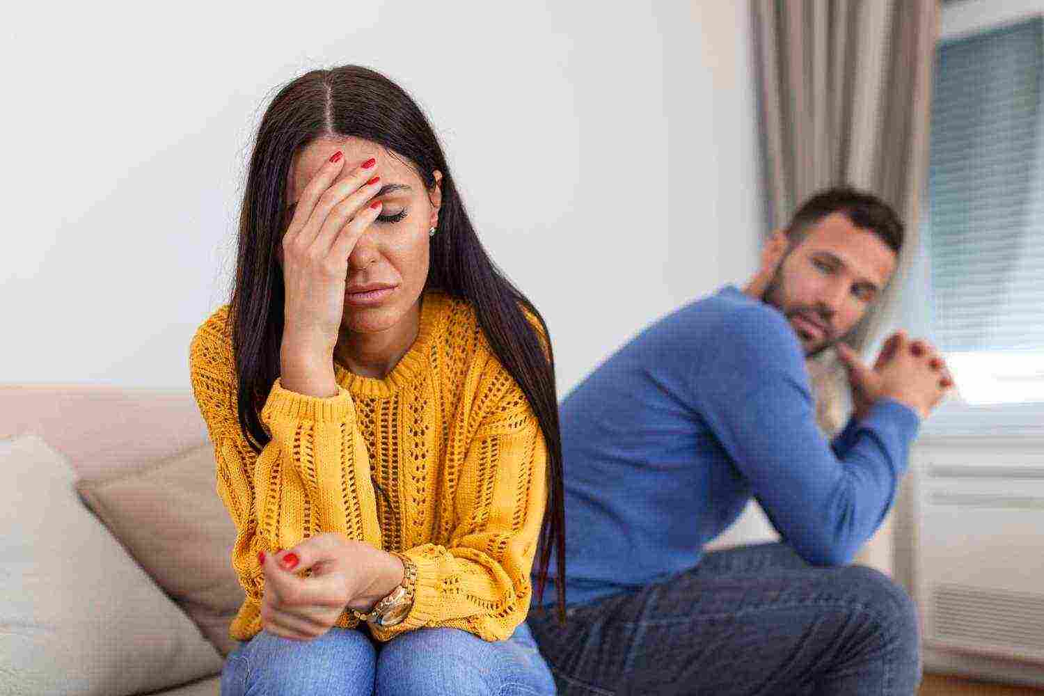 sad pensive young girl thinking relationships problems sitting sofa with offended boyfriend conflicts marriage