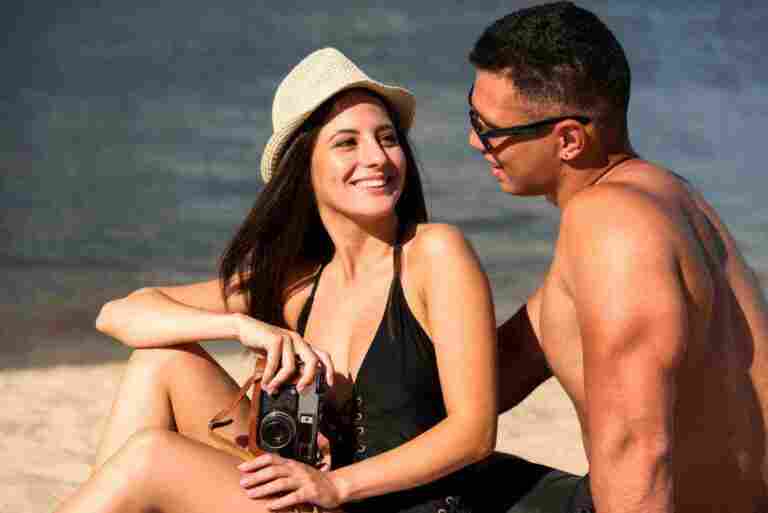 smiley couple enjoying their time beach