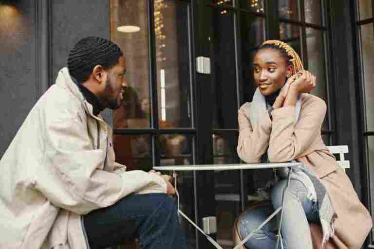 two young people sitting outside african couple enjoying time spending with each other