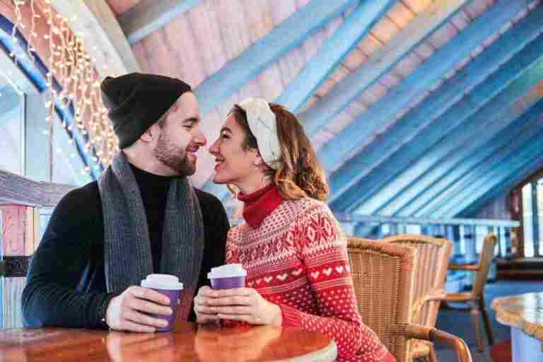 young attractive couple date cafe talking kissing christmas time