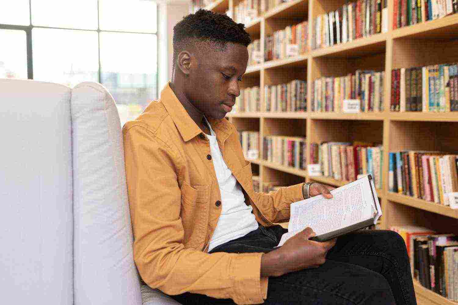 young student learning library