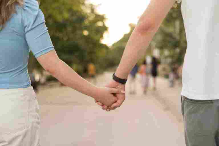 girl boy holding hands close up