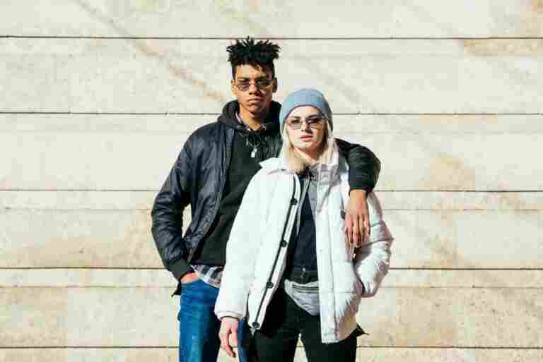 portrait young couple fashionable clothes standing against wall 1