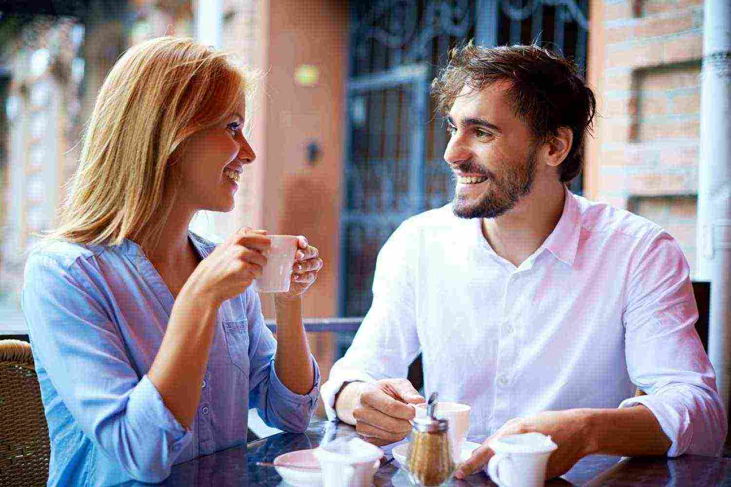 smiling couple drinking coffee looking each other1