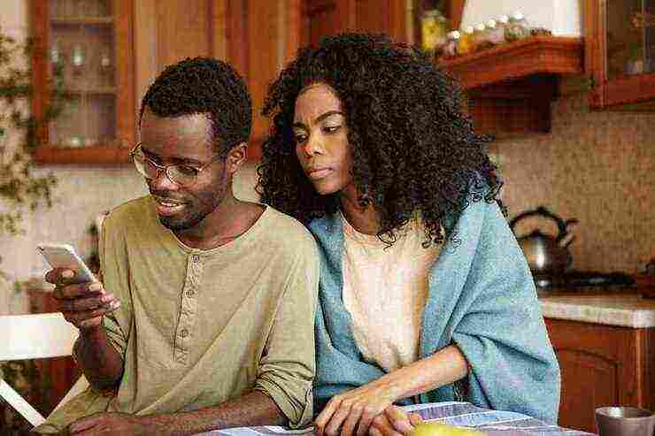 suspicious black wife trying read message that her happy husband sending someone mobile phone as she suspects betrayal trusting him jealousy infidelity distrust 273609 629