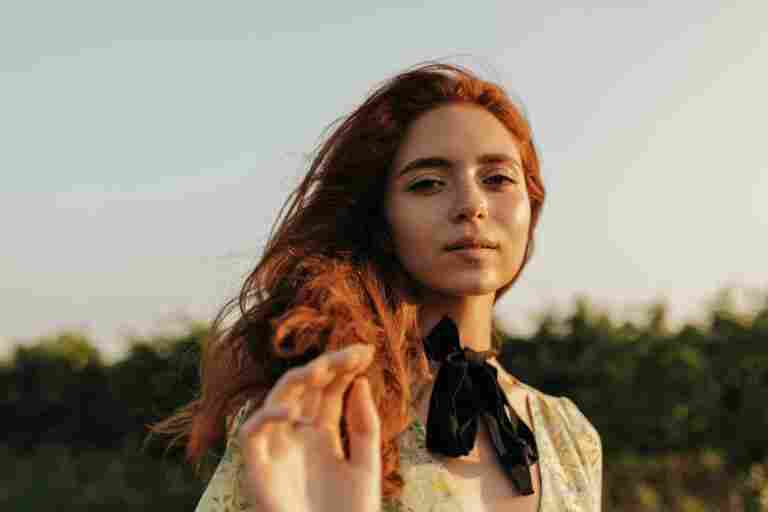beautiful lady with foxy wavy hair cute freckles black bandage neck summer charming dress looking front outdoor