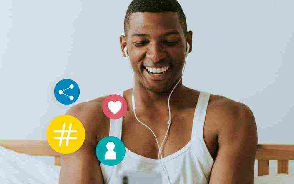 cheerful man playing his mobile phone bed edited