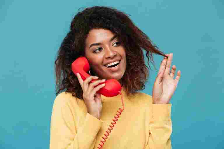 cheerful young african lady talking by telephone 1