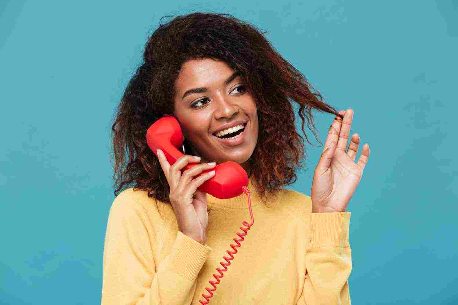 cheerful young african lady talking by telephone 1