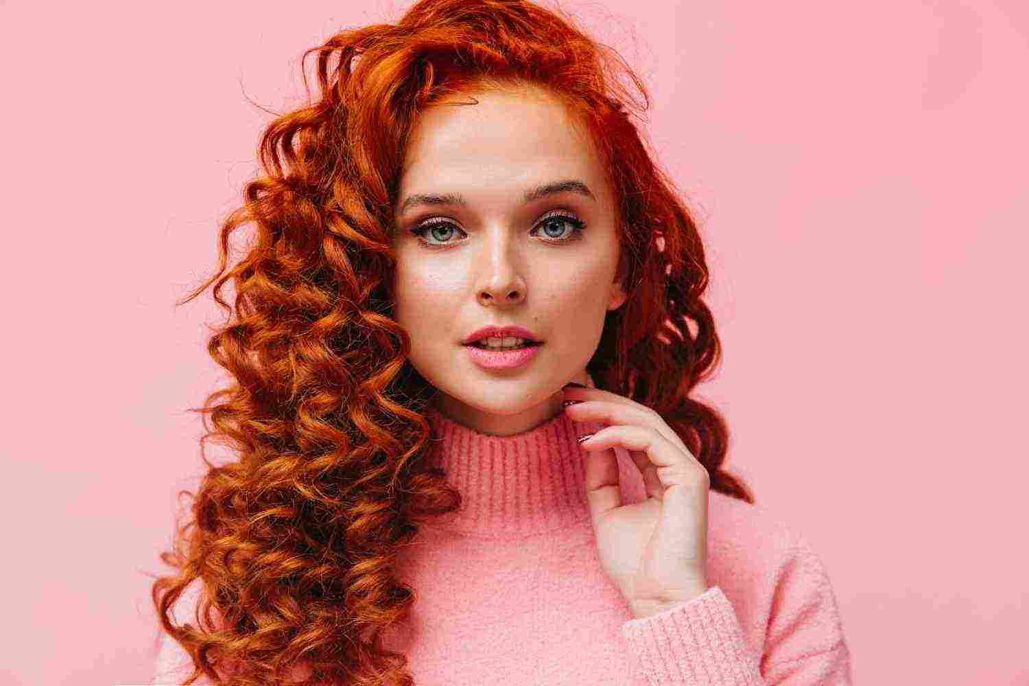 close up portrait curly redhead woman with blue eyes