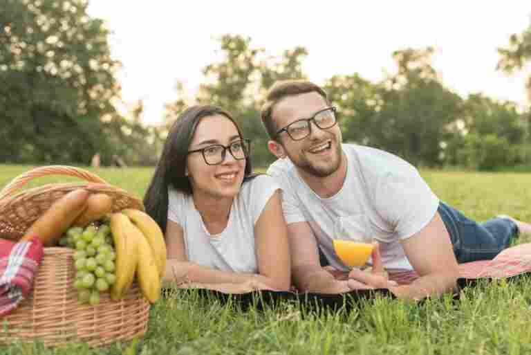 couple posing picnic blanket