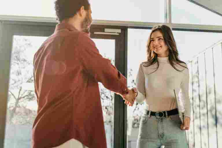 low angle business people hand shake