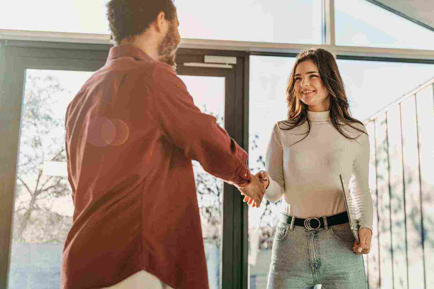 low angle business people hand shake