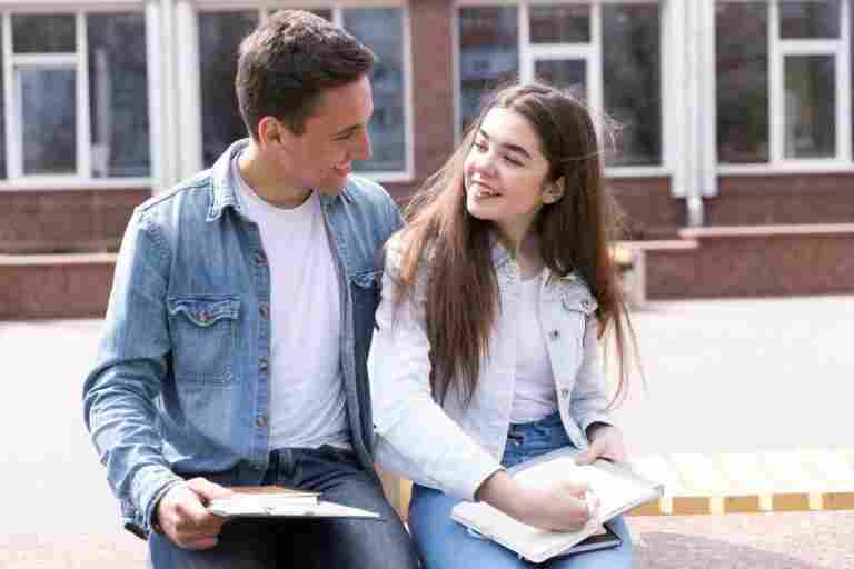 man woman sitting together with open books