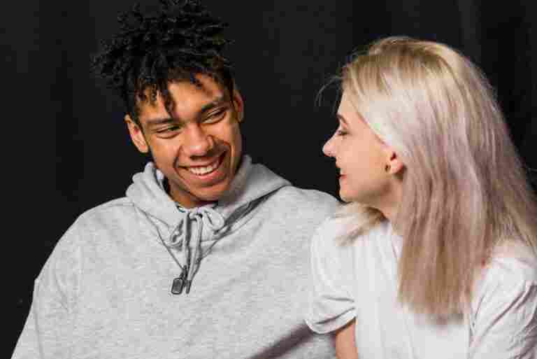 portrait happy young couple against black background