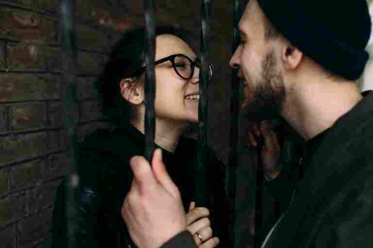 romantic couple separated by fence