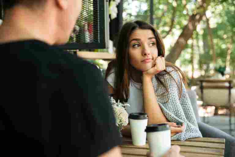 tired bored woman sitting drinking coffee