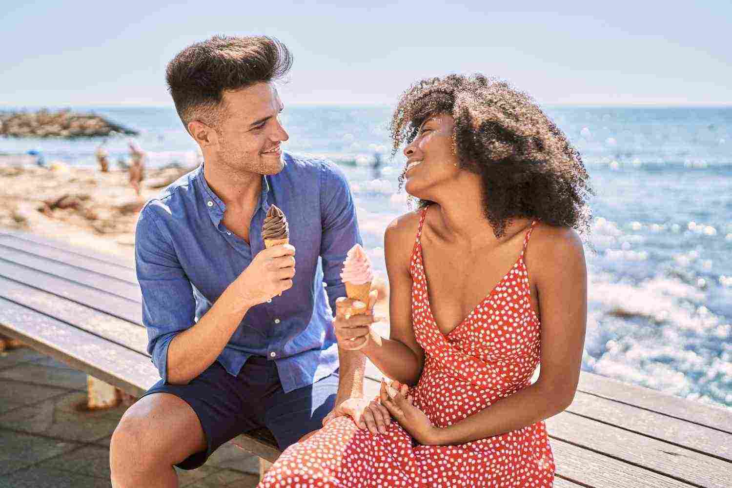 man woman couple smiling confident using smartphone seaside1
