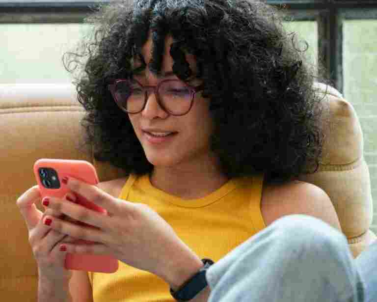 medium shot smiley woman holding phone