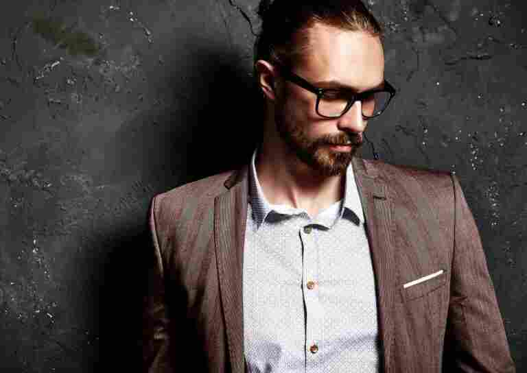 portrait handsome fashion stylish hipster businessman model dressed elegant brown suit glasses near dark wall