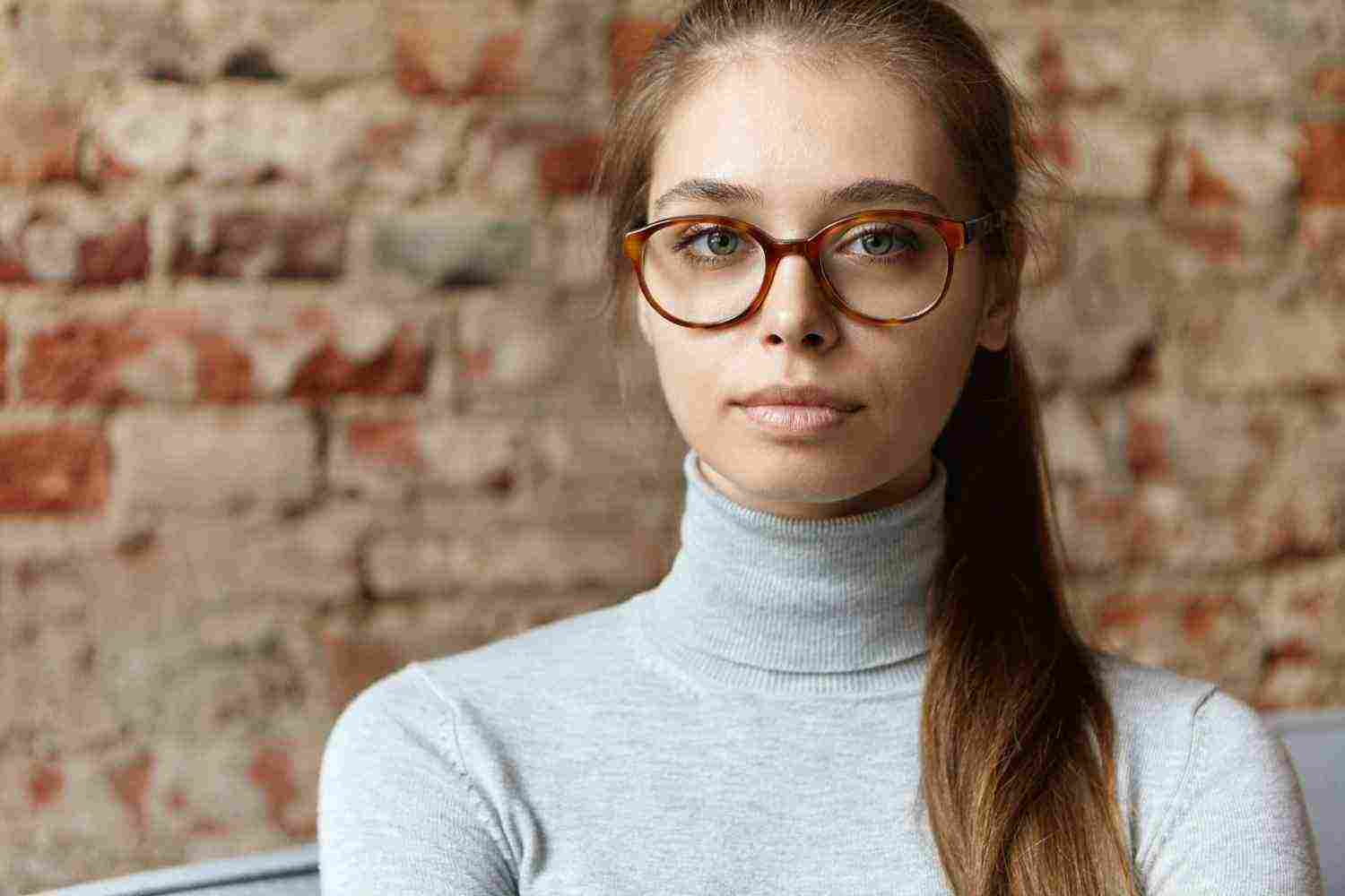 young woman wearing grey turtleneck eyeglasses 1 1