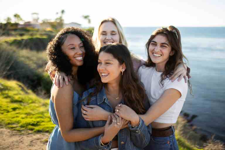 medium shot happy women posing seaside