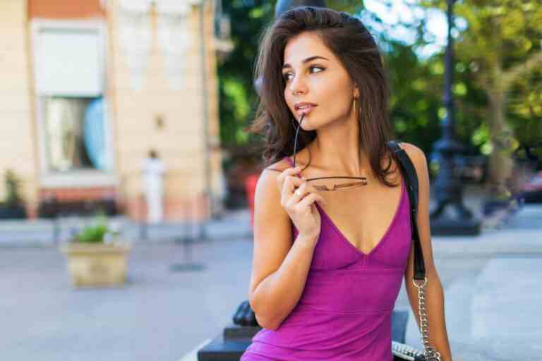 outdoor fashion image pretty graceful woman stylish velvet dress waiting somebody dreaming enjoying free time street warm sunny colors brunette wavy hairstyle