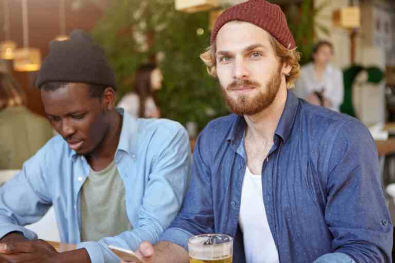 people modern lifestyle friendship relationships technologies concept two handsome stylish men relaxing cafe bar drinking beer having nice time using free wifi mobile phones