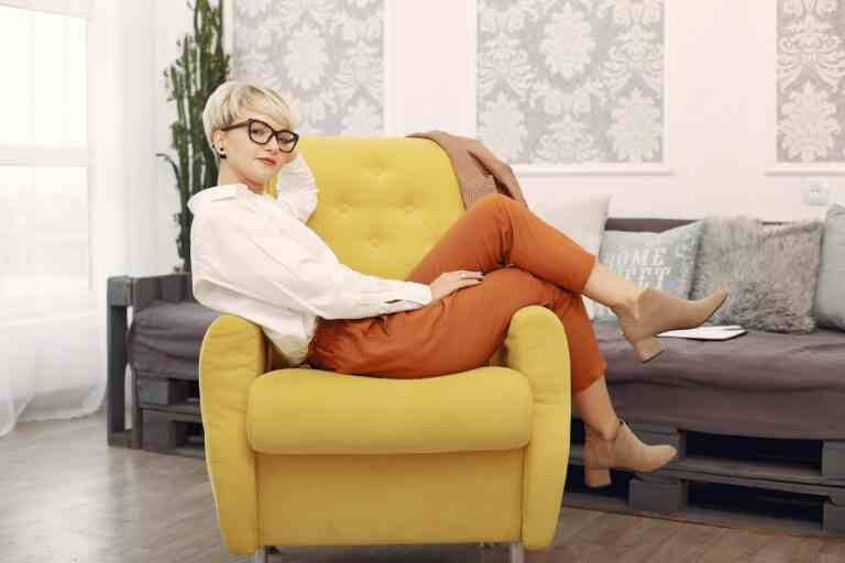 psychologist with glasses sitting chair office