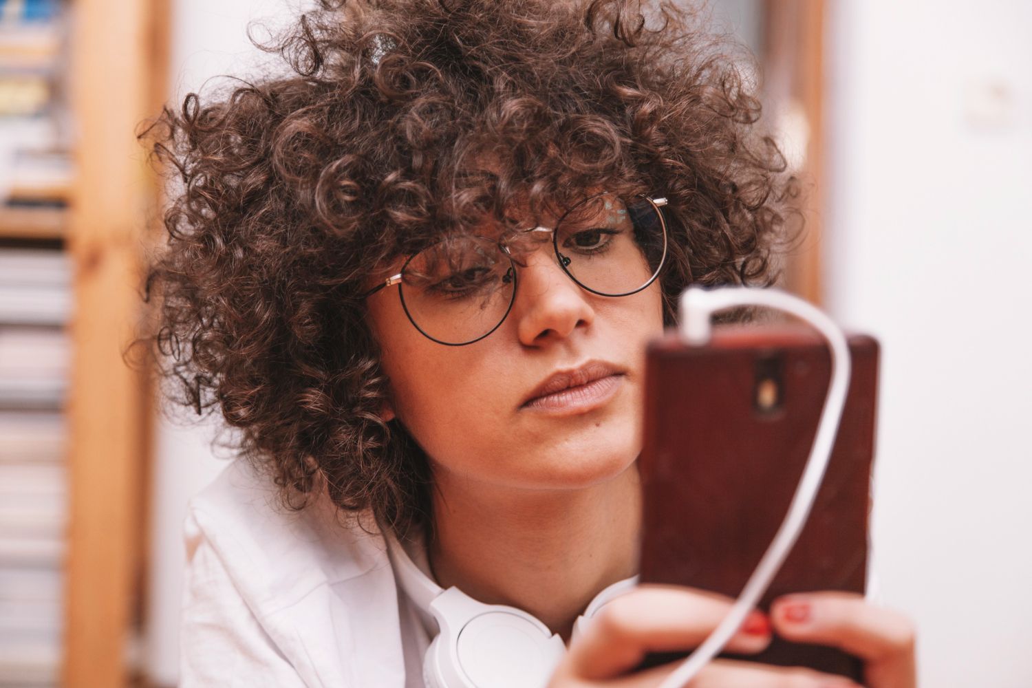 serious teenager browsing smartphone