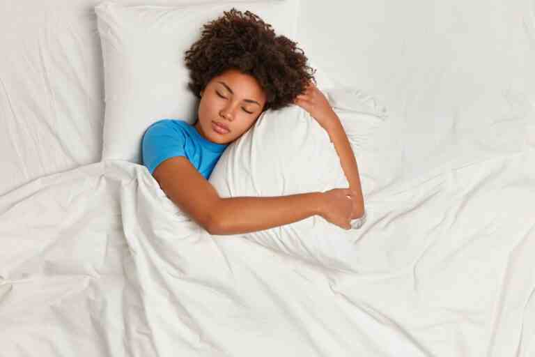 young brunette woman lying bed