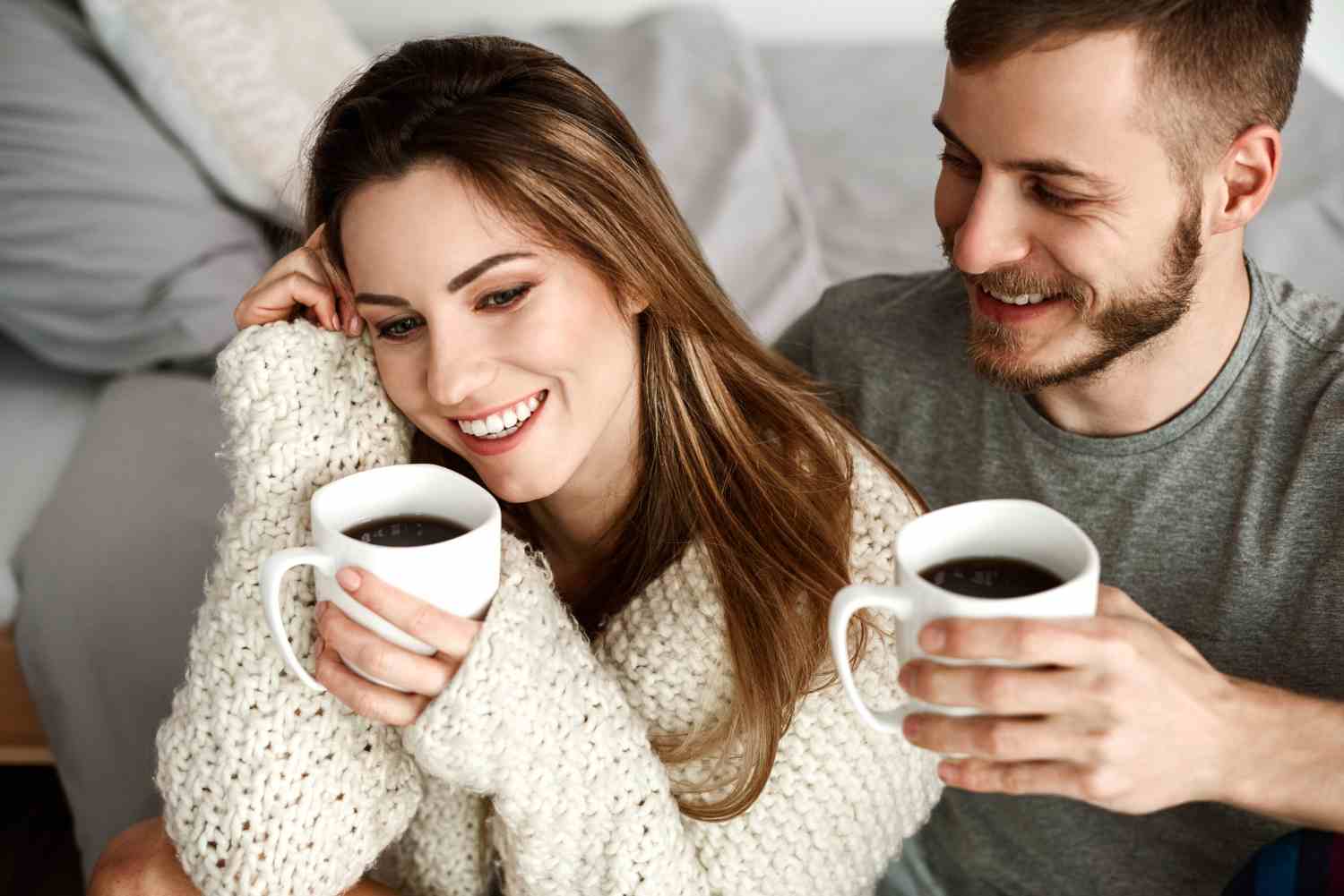 cheerful heterosexual couple drinking coffee