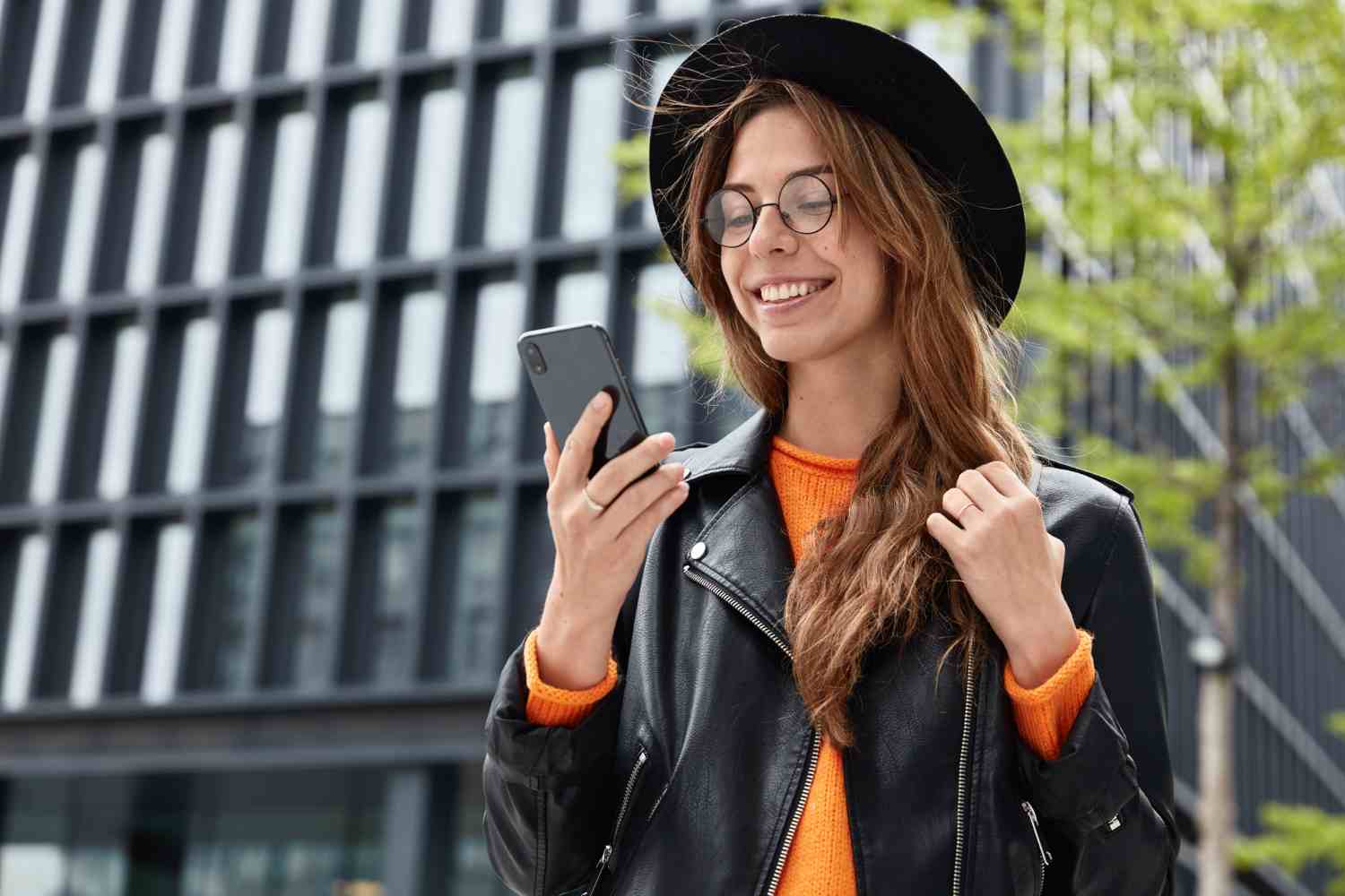 cheerful hipster girl wears stylish black hat leather jacket round transparent spectacles