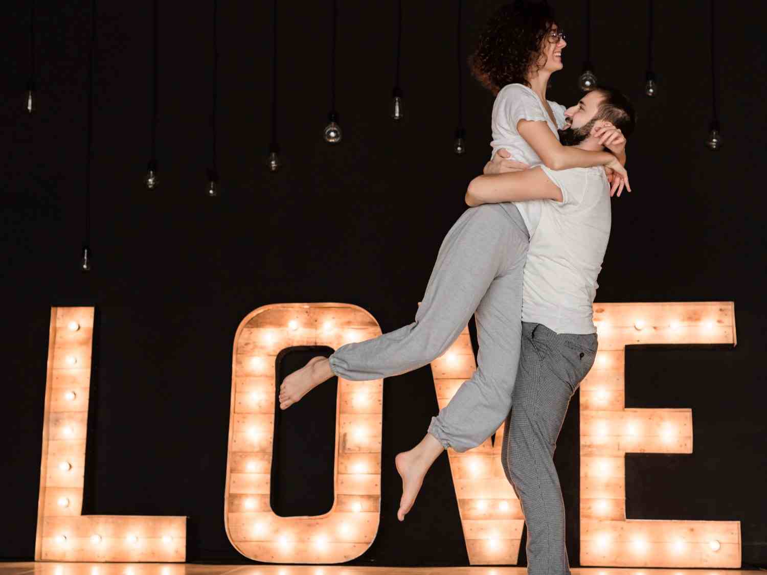 man lifting girlfriend romantically in dance