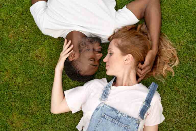medium shot romantic couple grass