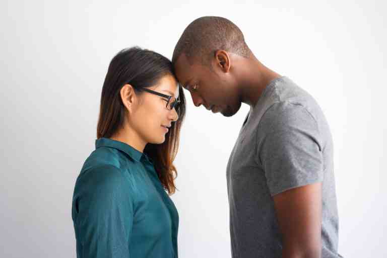romantic multiracial couple touching their foreheads