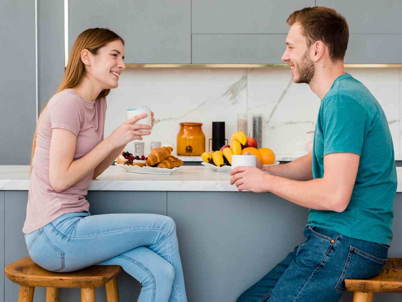 side view couple holding cup kitchen