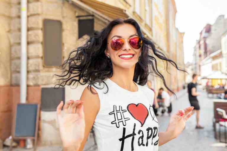 young beautiful woman walking old city street