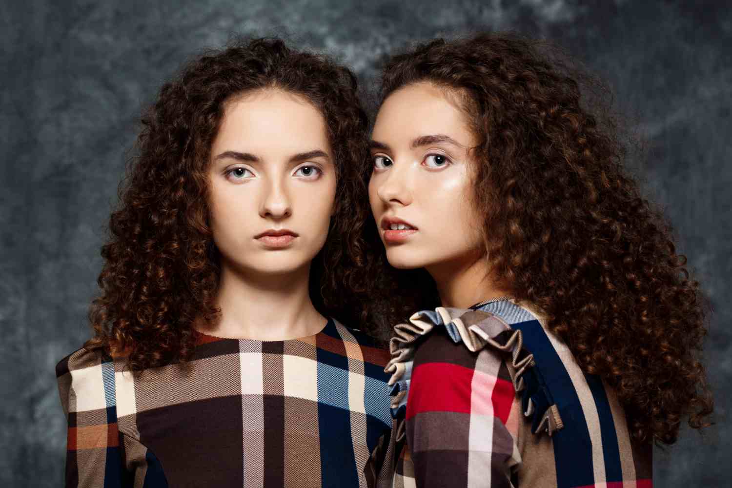 sisters twins posing grey